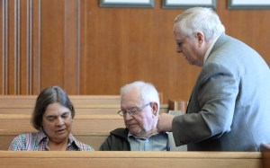 Bruner confers with village board member Karen Van Lone. Her husband, Richard Britton, is with her.